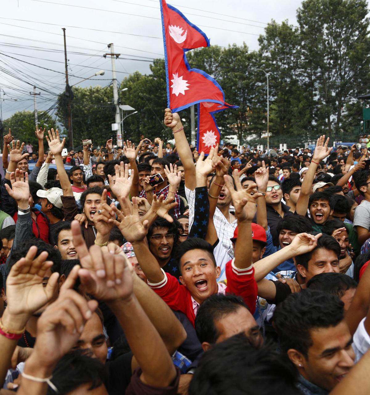 Nepali people gather to celebrate the adoption of the country’s new constitution, outside the constituent assembly hall in Kathmandu, Nepal, Sunday, Sept. 20, 2015. Nepali President Ram Baran Yadav signed the constitution and made the proclamation announcement, setting off a roar of applause from members of the Constituent Assembly in Kathmandu. The new constitution replaced an interim one that was supposed to be in effect for only a couple of years but had governed the nation since 2007. Nepali people gather to celebrate the adoption of the country’s new constitution, outside the constituent assembly hall in Kathmandu, Nepal, Sunday, Sept. 20, 2015. Nepali President Ram Baran Yadav signed the constitution and made the proclamation announcement, setting off a roar of applause from members of the Constituent Assembly in Kathmandu. The new constitution replaced an interim one that was supposed to be in effect for only a couple of years but had governed the nation since 2007.