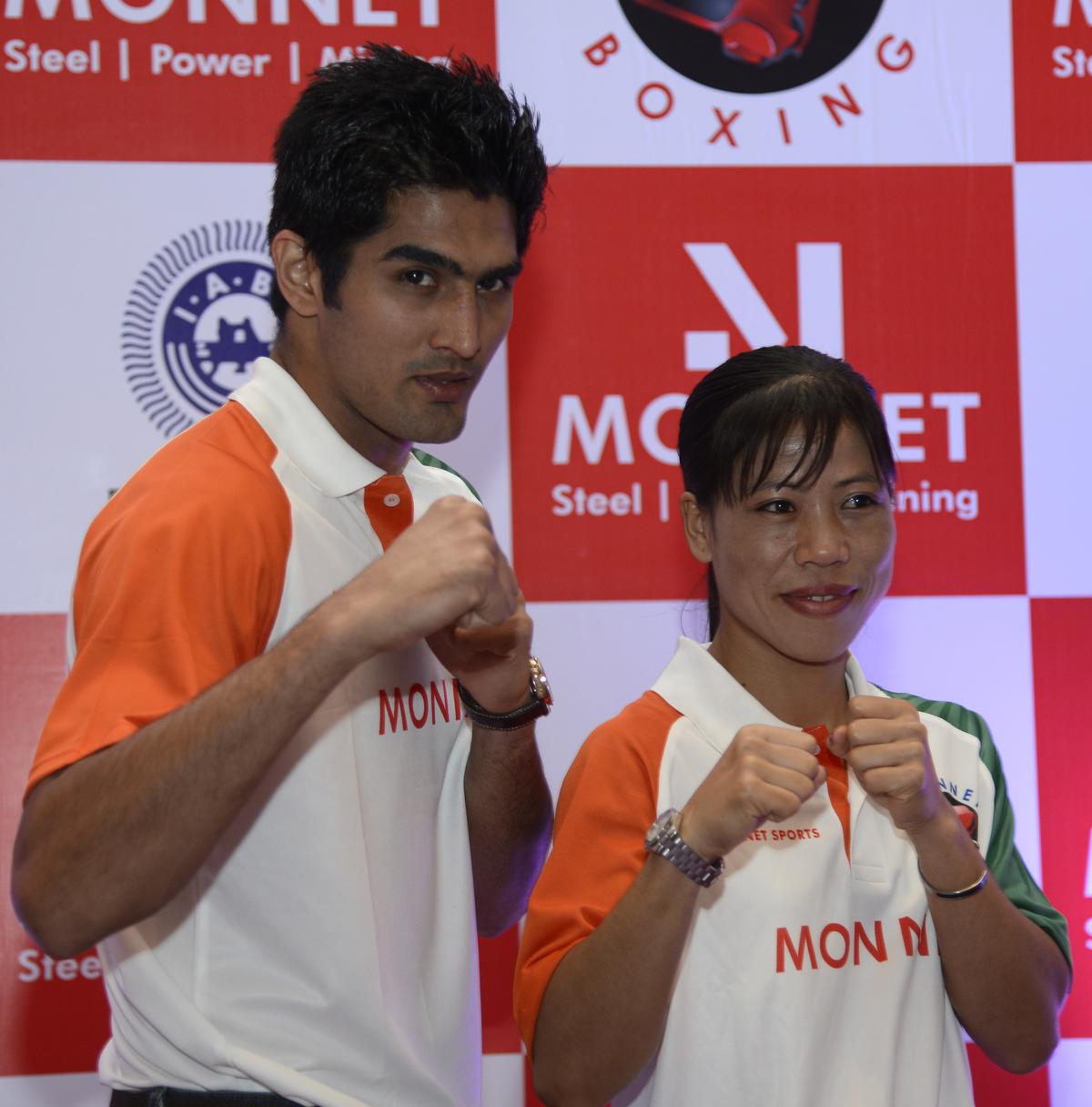 File photo of Olympic boxers Vijender Singh and MC Mary Kom during a felicitation function  in New Delhi.