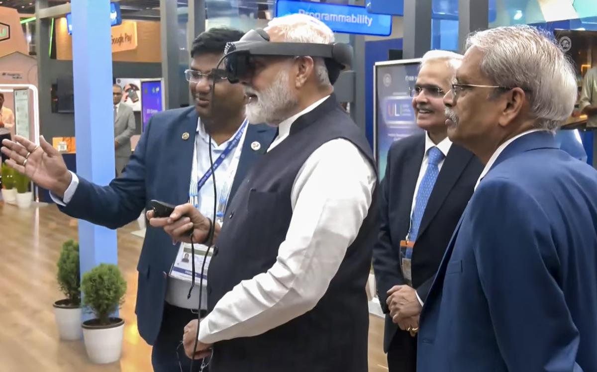 Prime Minister Narendra Modi looks at a Virtual Reality (VR) demonstration during a visit to an exhibition at the Global FinTech Fest, in Mumbai, Friday, Aug 30, 2024. RBI Governor Shaktikanta Das is also seen.