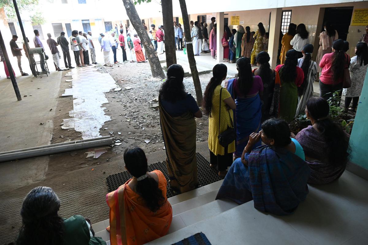 People standing in a queue to cast their vote at a polling booth in Vennala on December 9.  
