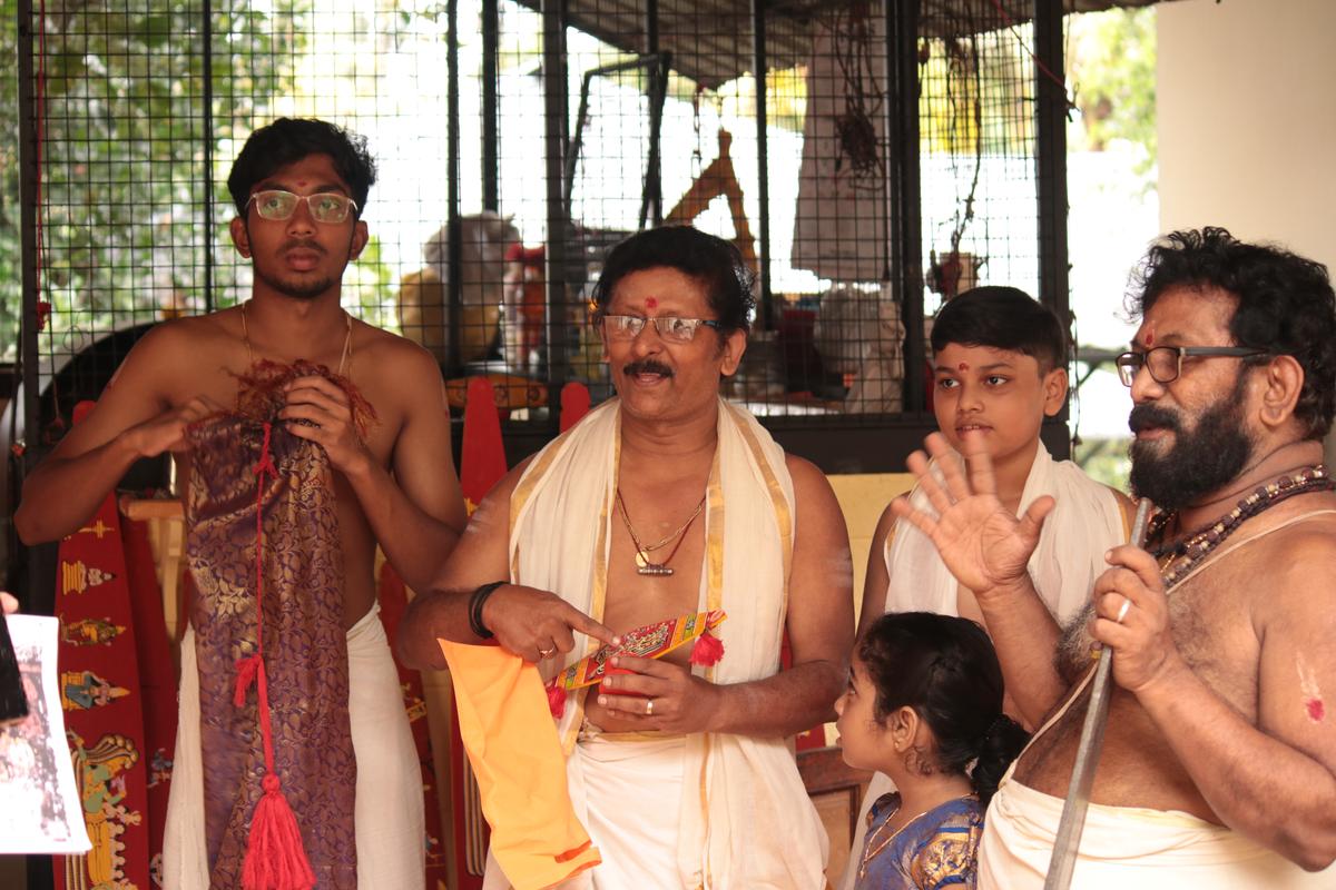 Vilayilveedu family members with an antique  Onavillu in teak. 