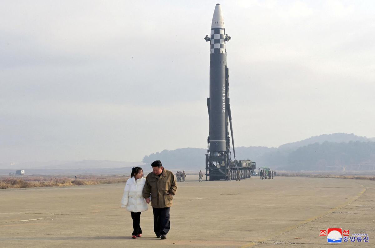 North Korean leader Kim Jong Un, along with his daughter, walks away from an intercontinental ballistic missile (ICBM) in this undated photo released on November 19, 2022 by North Korea’s Korean Central News Agency (KCNA)