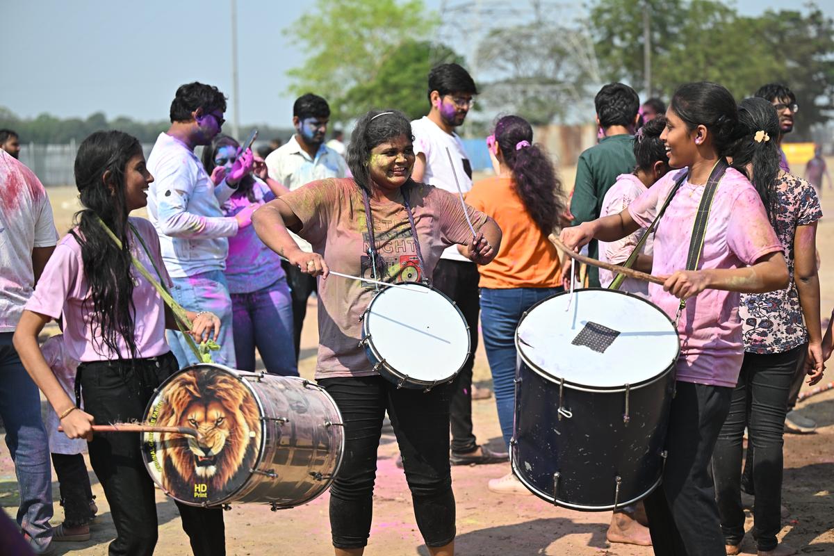 Girls beating drums as part of the Holi celebrations, at Babburi ground, near Punnami Ghat, in Vijayawada on Friday. 