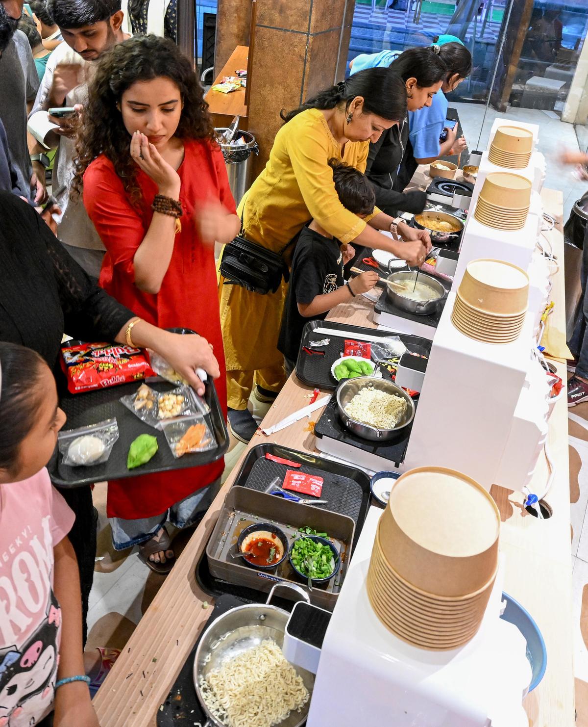 People making their ramyun at the newly-opened restaurant Genz ramyun, a self serve Korean ramyun bar, at Beach Road in  Visakhapatnam.