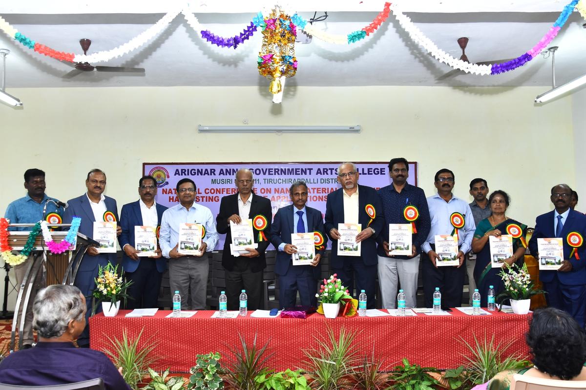 Participants with copies of the proceedings of a conference on nanomaterials for energy harvesting and storage applications organised by the Department of Physics, Arignar Anna Government Arts College, Musiri.