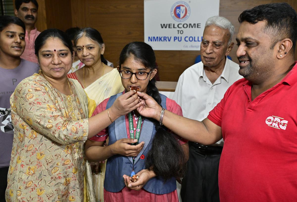 Medha D., Arts topper, celebrating with her parents and grandparents in Bengaluru on Wednesday. 