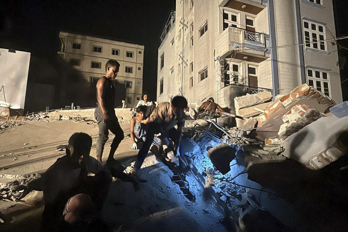 Volunteers work at the site of a building that collapsed after an earthquake in Mandalay, central Myanmar, on March 29, 2025. Volunteers work at the site of a building that collapsed after an earthquake in Mandalay, central Myanmar, on March 29, 2025.