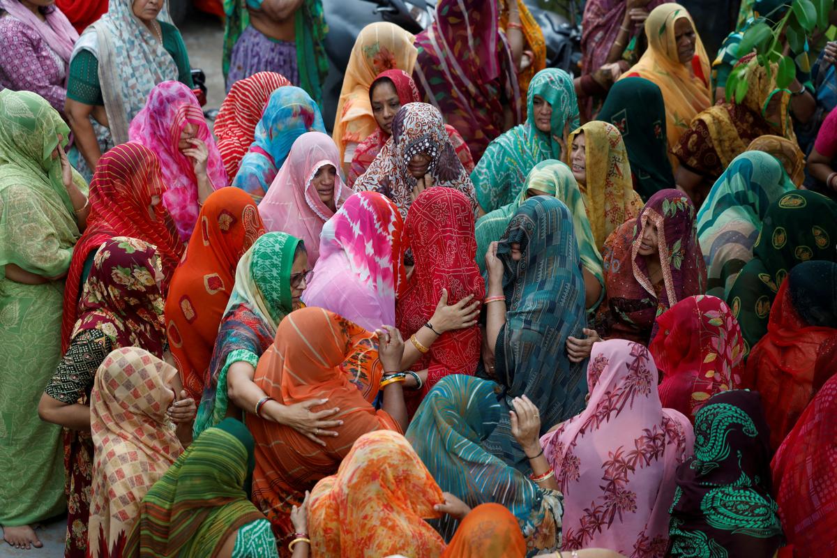 Family members and relatives mourn during the funeral of Chetnaba Chavda and her husband Ranvirsinh Chavda, who died in the Air India Boeing 787-8 Dreamliner plane crash, in Ahmedabad on June 18, 2025.