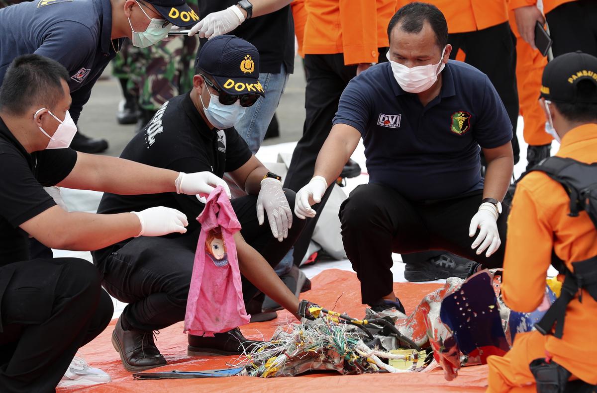Investigators sort debris found on the waters off Java Island around where a Sriwijaya Air passenger jet crashed, at Tanjung Priok Port in Jakarta, Indonesia, Sunday, Jan. 10, 2021 Investigators sort debris found on the waters off Java Island around where a Sriwijaya Air passenger jet crashed, at Tanjung Priok Port in Jakarta, Indonesia, Sunday, Jan. 10, 2021