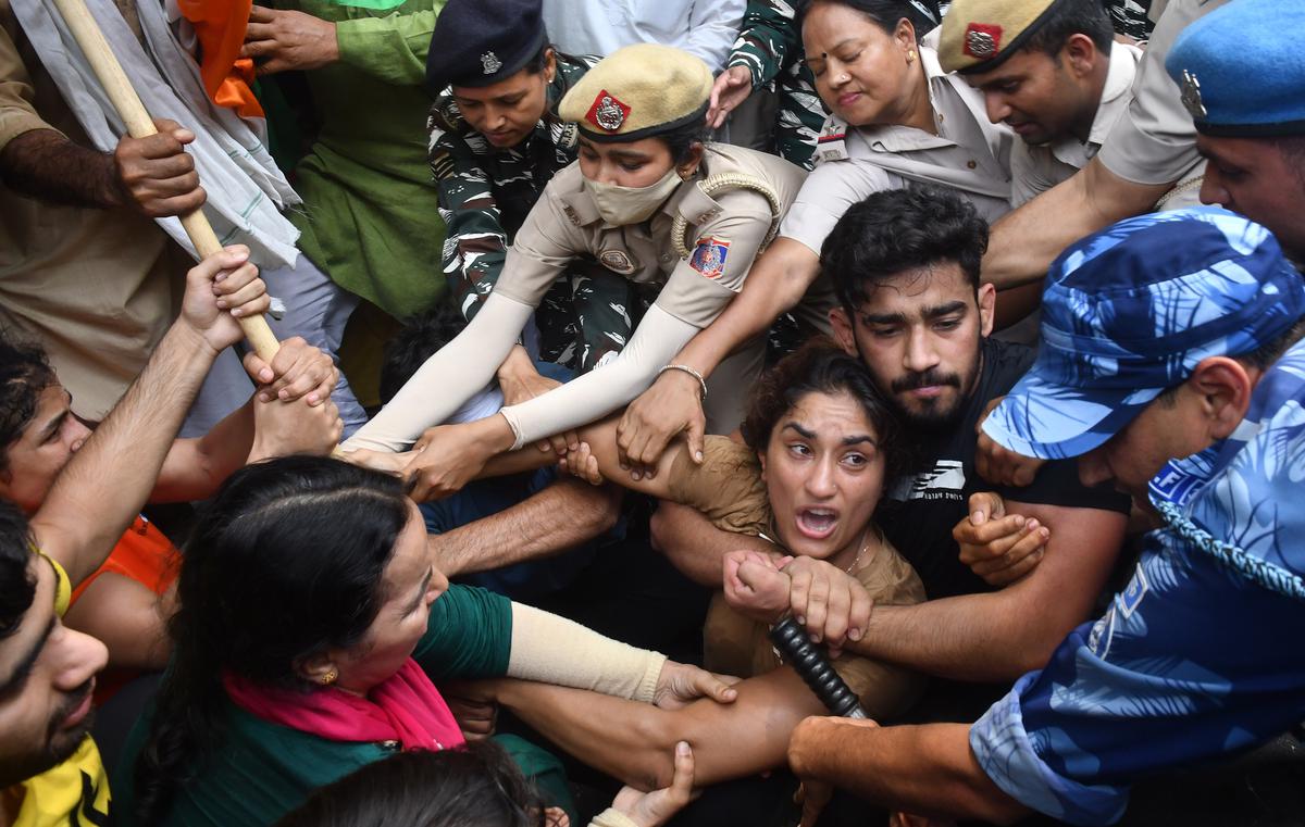 Wrestlers Vinesh Phogat and Sangeeta Phogat with others being detained by the security personnel on May 28, 2023.