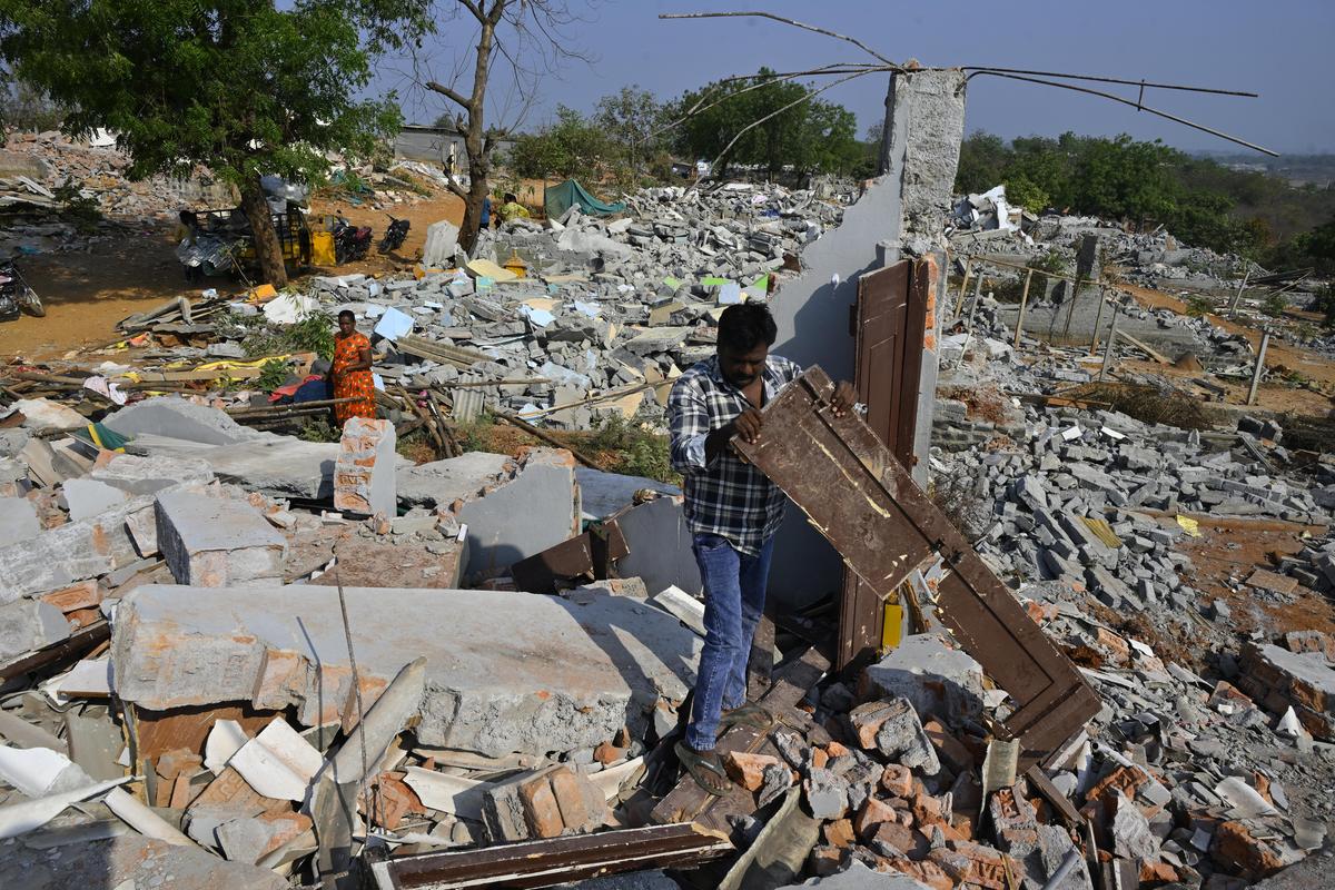 A scrap dealer rummaging through the wreckage for bits of iron salvaged from the rubble.