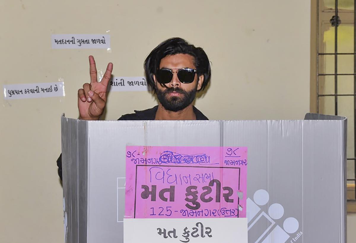Cricketer Ravindra Jadeja casts his vote during the first phase of Gujarat Assembly elections, in Jamnagar.