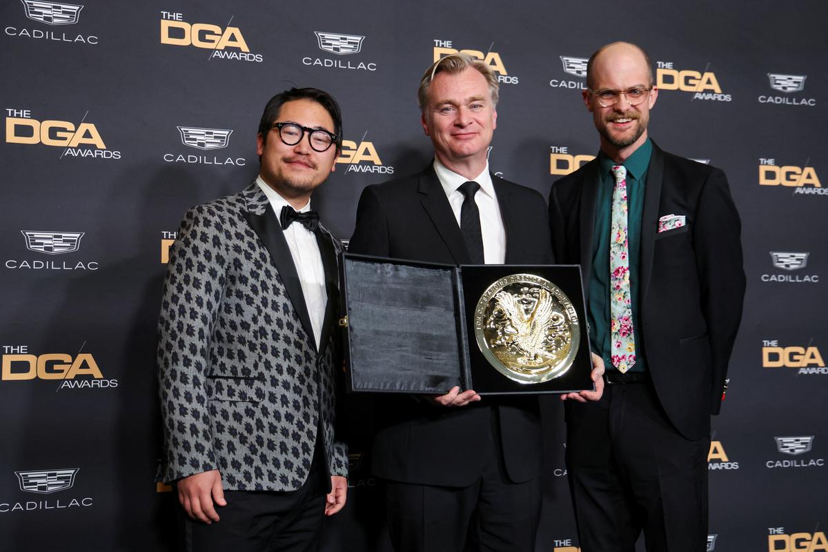 Director Christopher Nolan holds the award for Outstanding Directorial Achievement in Theatrical Feature Film as he poses with the Daniels, at the 76th Annual DGA (Directors Guild of America) Awards 