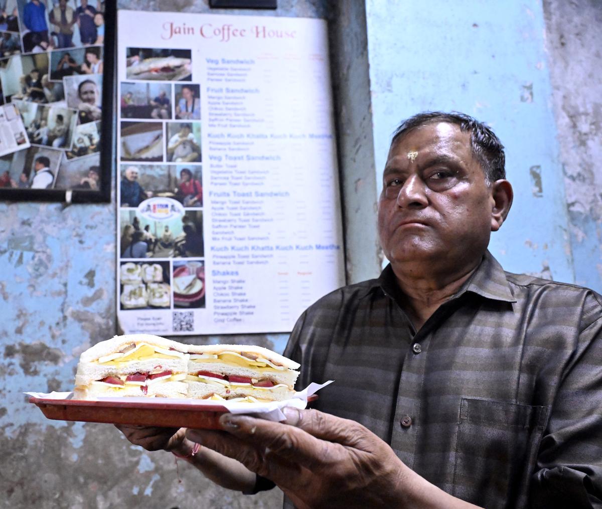 Anil Jain holds the popular fruit sandwich at the Jain Coffee House, Chawri Bazar area in Old Delhi SHIV KUMAR PUSHPAKAR Anil Jain holds the popular fruit sandwich at the Jain Coffee House, Chawri Bazar area in Old Delhi SHIV KUMAR PUSHPAKAR