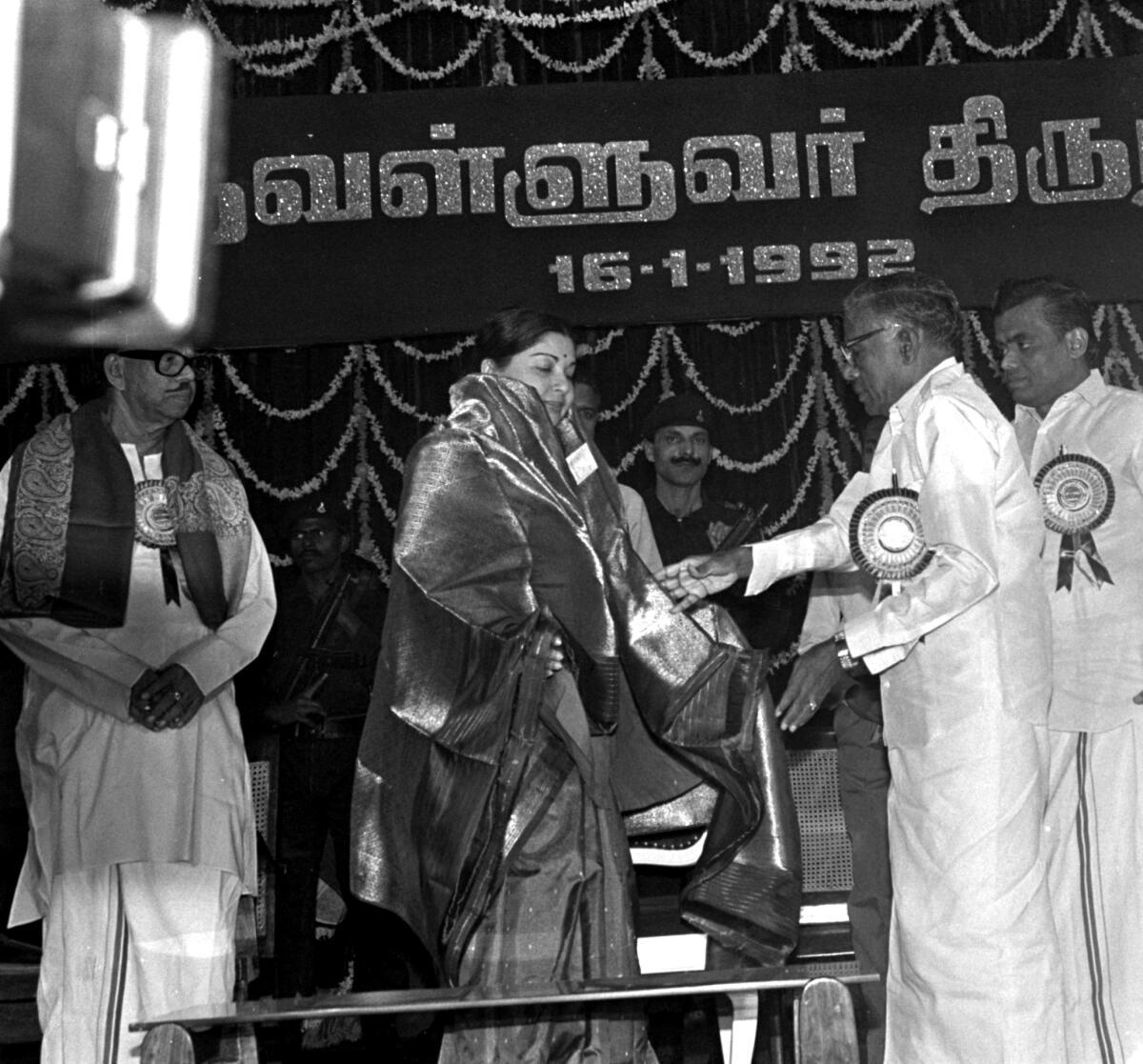 The Chief Minister, Ms. Jayalalitha, being welcomed by the Mr. R.M. Veerappan, Minister for Education at a Thiruvalluvar Award function at the Kalaivanar Arangam in Madras on January 16, 1992. Mr. R. Muthiah, Speaker of the Tamil Nadu Assembly, Mr. V.R. Nedunchezhian, Minister for Finance and others look on