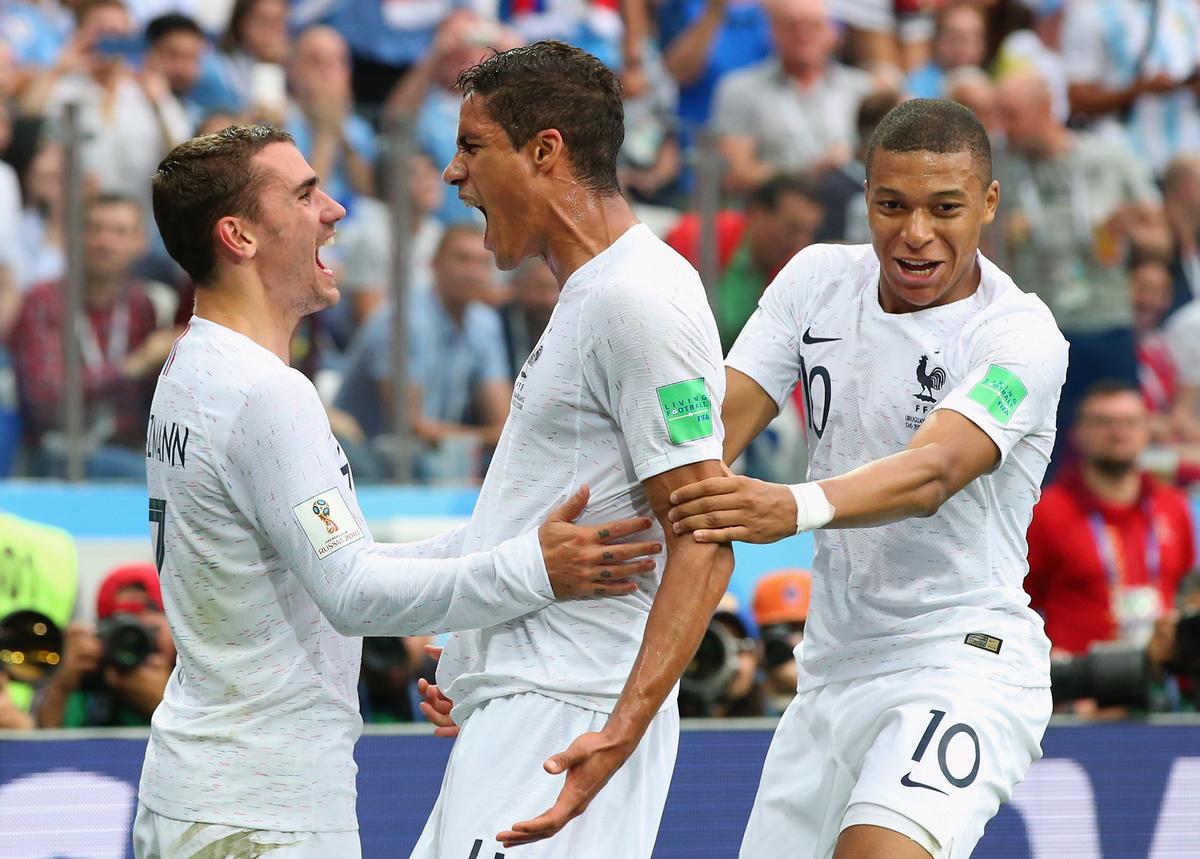 File picture of Raphael Varane, centre, celebrating with France teammates Kylian Mbappe and Antoine Griezmann after scoring for his team during the 2018 FIFA World Cup in Russia