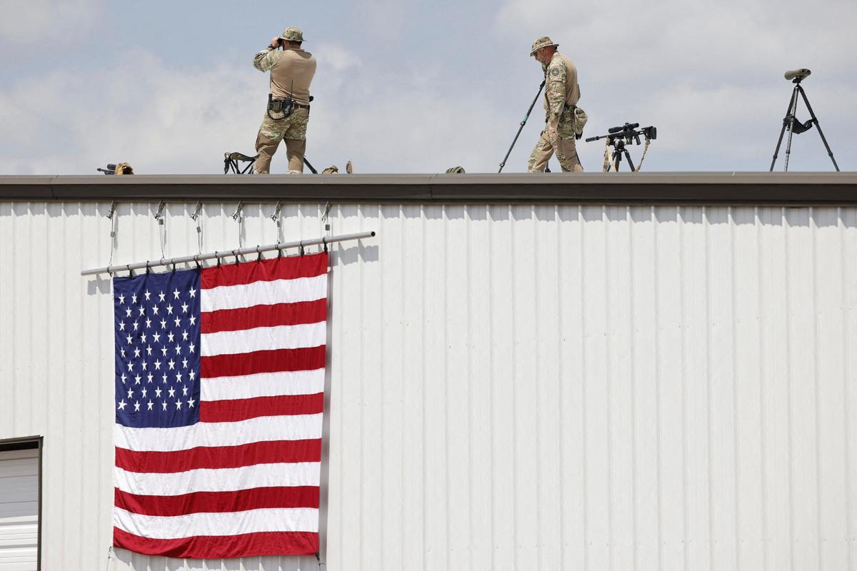 Security forces members keep watch on the day of a campaign rally held by  former U.S. President Donald Trump at Asheboro Regional Airport in Asheboro, North Carolina.