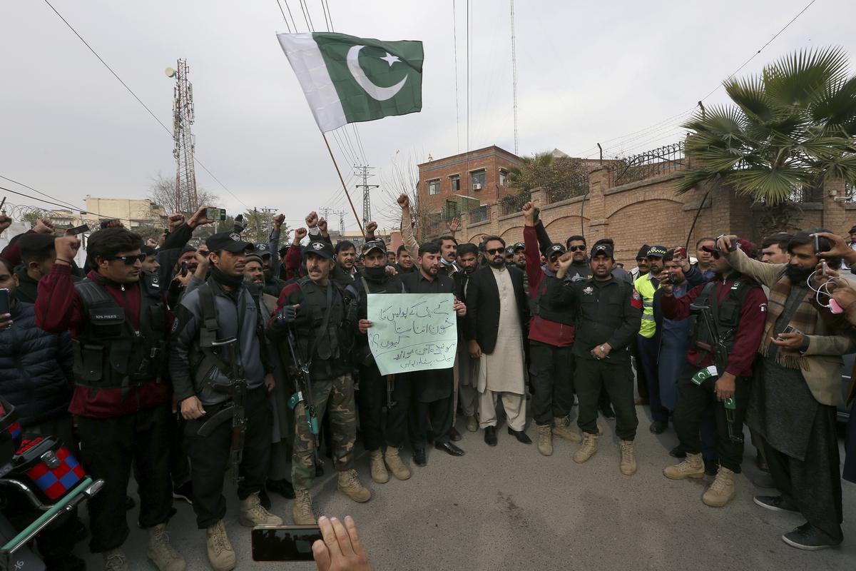 Police officers chant slogans as they take part in a peace march organized by a civil society group denouncing militant attacks and demanding peace in the country, in Peshawar, Pakistan, on Feb. 1, 2023.