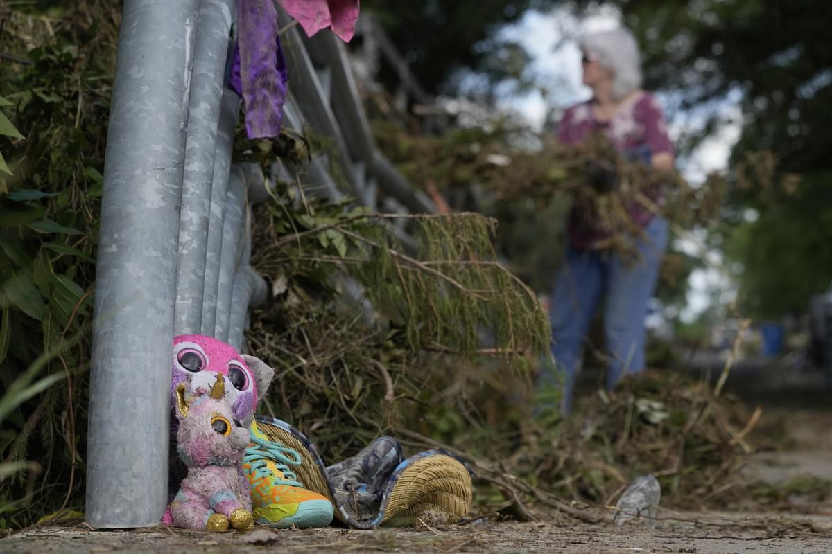 Lost items sit at a bridge as a volunteer cleans up debris in Kerrville, Texas. Lost items sit at a bridge as a volunteer cleans up debris in Kerrville, Texas.