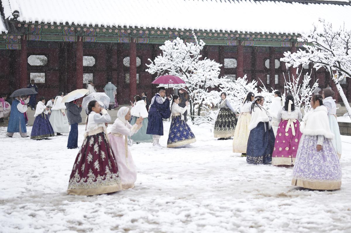 Visitors enjoy in snow at the Gyeongbok Palace, one of South Korea’s well-known landmarks, in Seoul, South Korea, on November 27, 2024. 