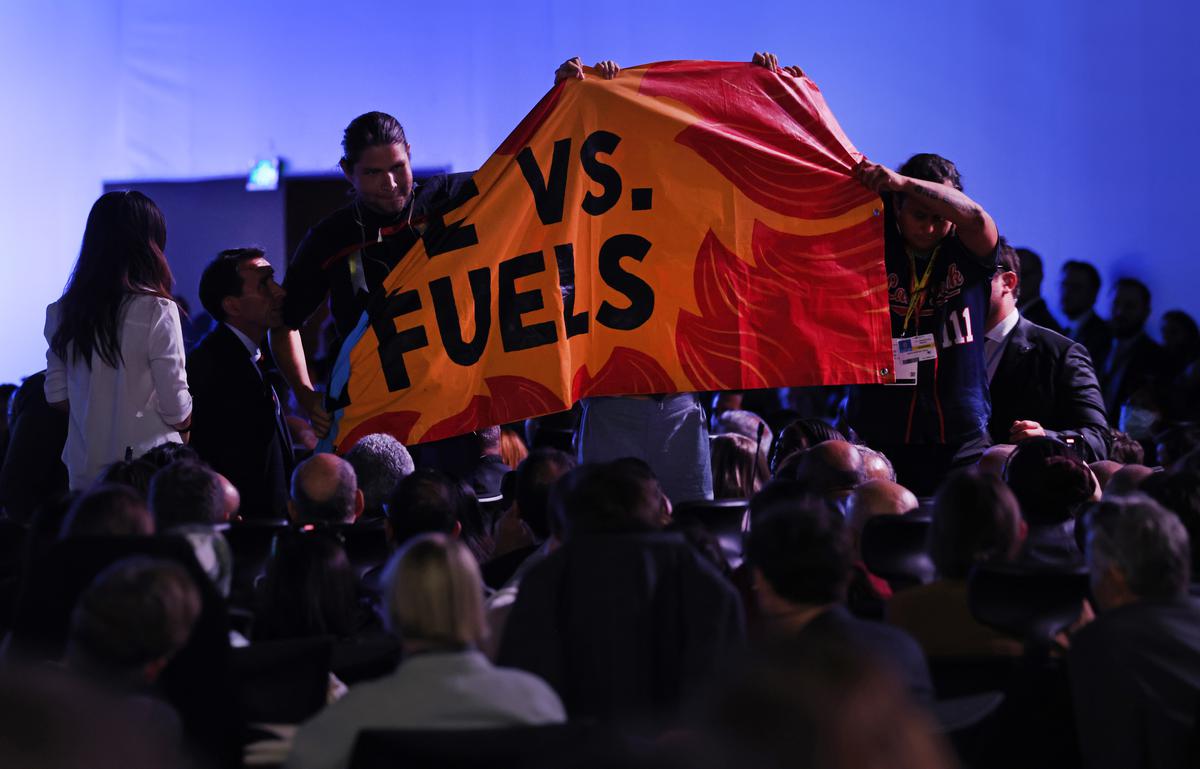 People protesting against fossil fuels attempt to unfurl a banner during the speech of U.S. President Joe Biden at the COP27 climate conference on November 11, 2022 in Sharm El Sheikh, Egypt.