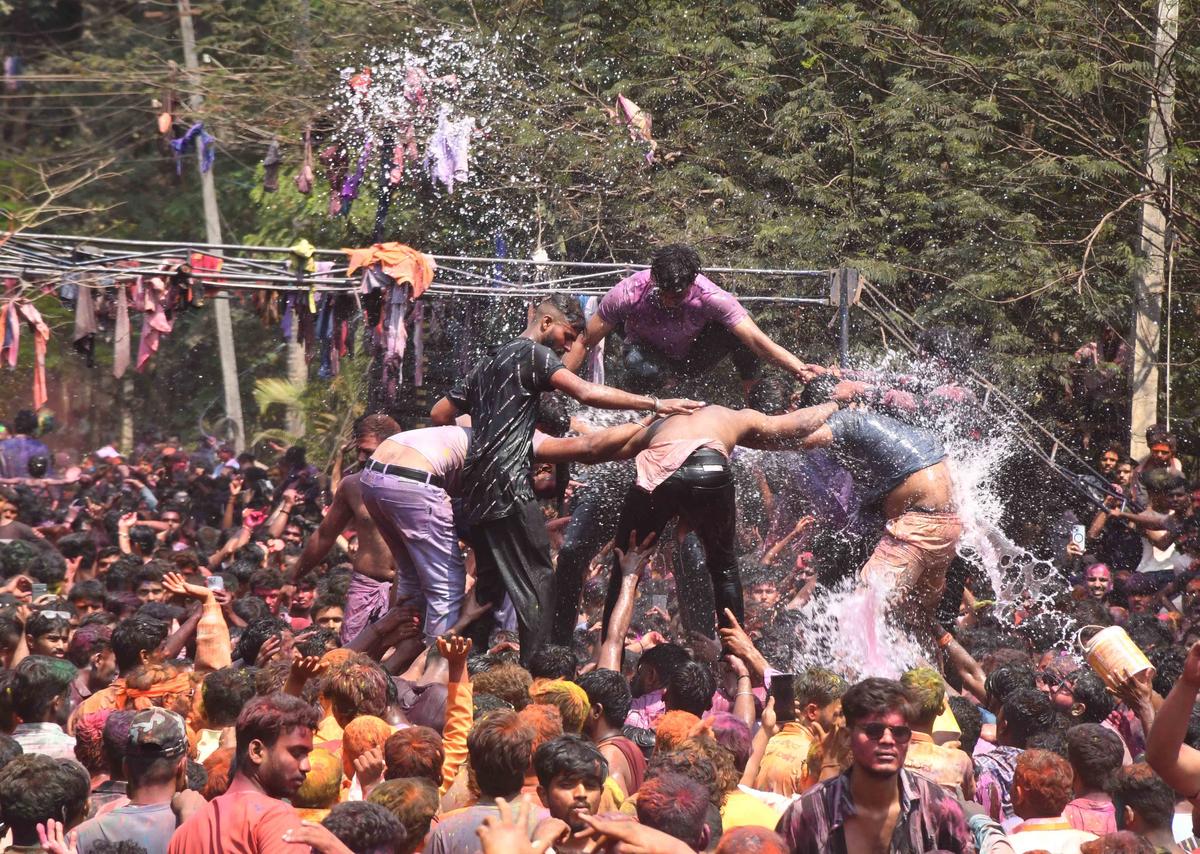 People taking part in Holi celebrations in Dharwad on Saturday. 