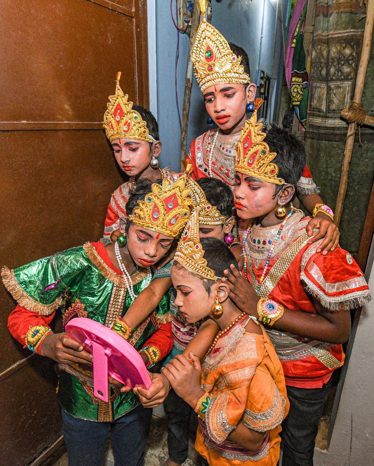 Young artistes check their costumes before showtime at Kasavalanadu Kollangarai village near Thanjavur. 