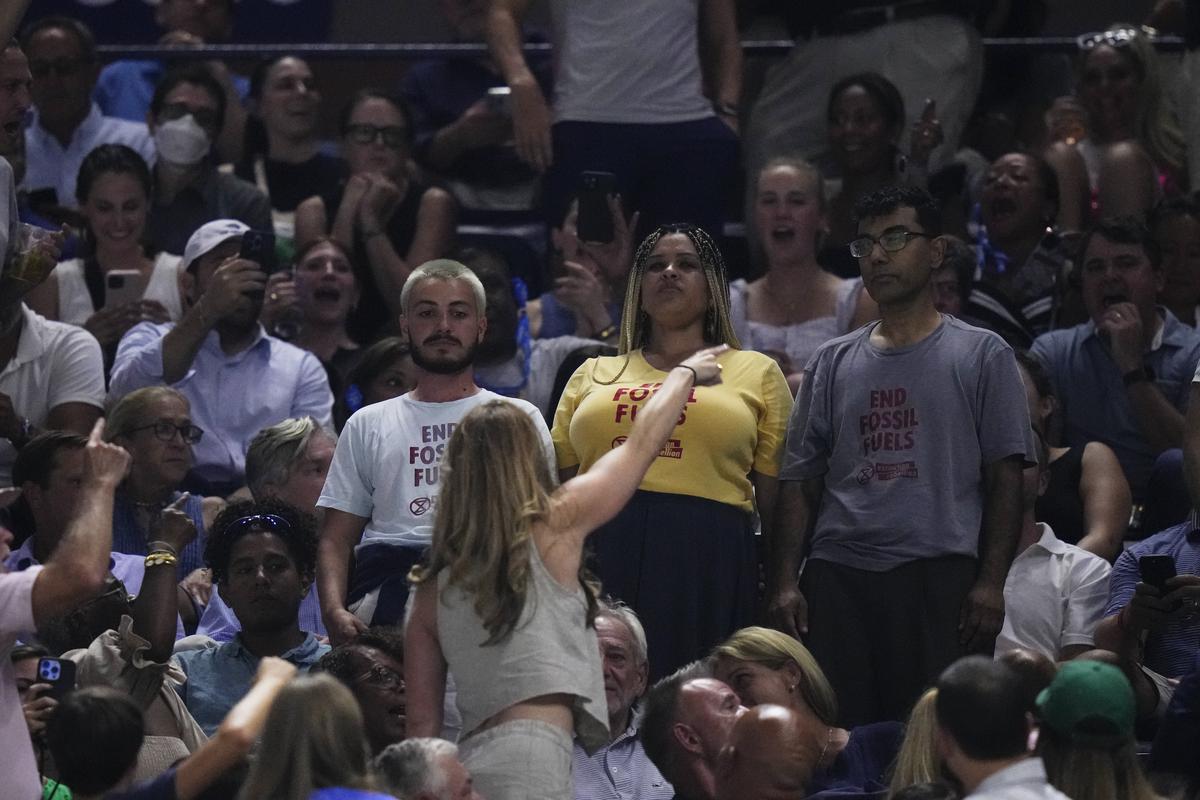 An audience member yells at protesters as they demonstrate at a match between Coco Gauff, of the United States, and Karolina Muchova, of the Czech Republic, during the women’s singles semifinals of the U.S. Open tennis championships, on September 7, 2023, in New York. 