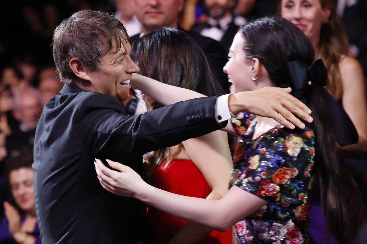 Director Sean Baker, Palme d’Or award winner for the film ‘Anora’, embraces Mikey Madison during the closing ceremony of the 77th Cannes Film Festival