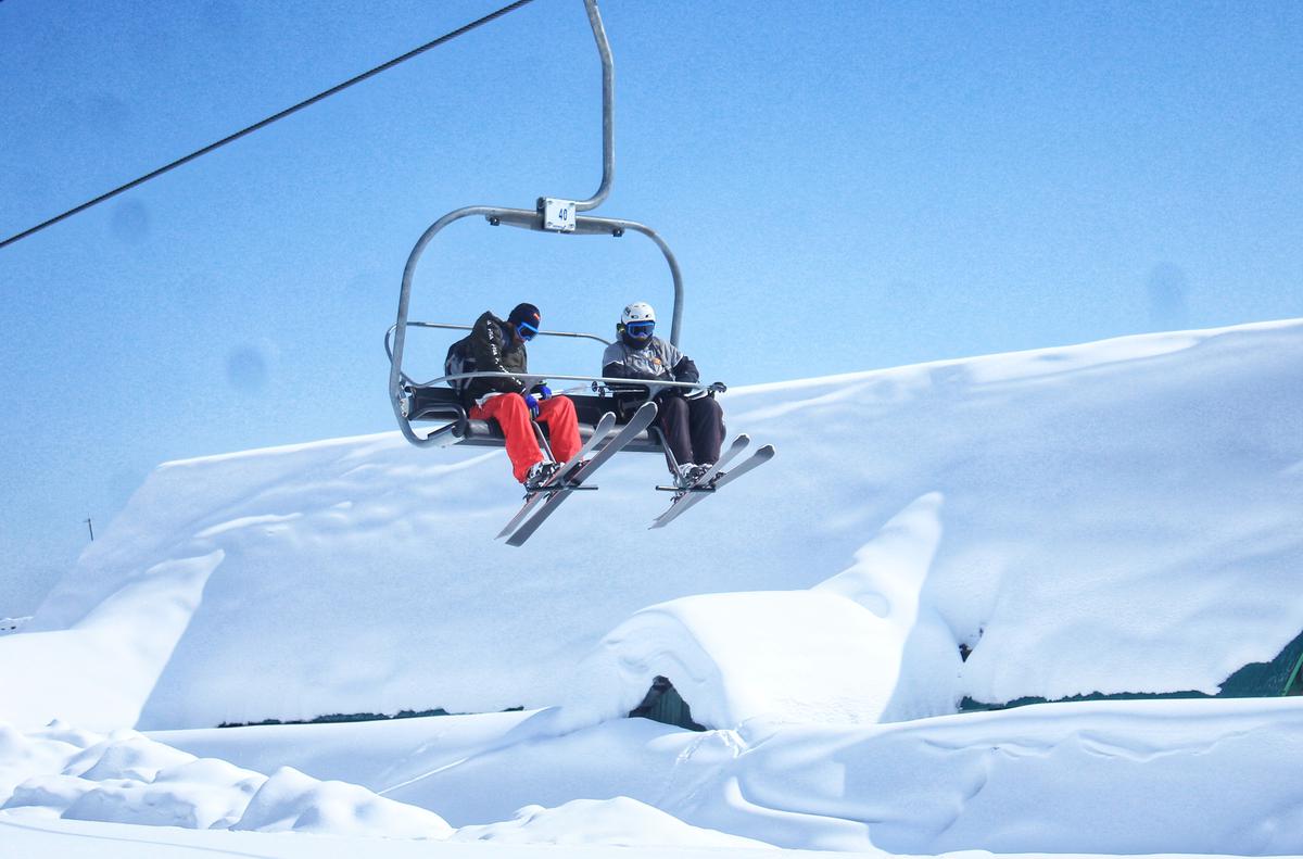 Skiers take the chairlift in Gulmarg