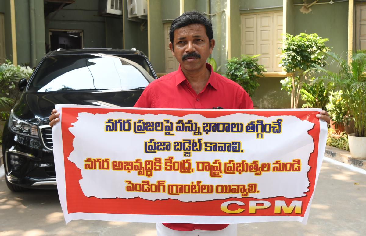 A CPI(M) corporator staging a protest saying that the city residents need a budget that reduces the tax burden, in Vijayawada on Saturday.