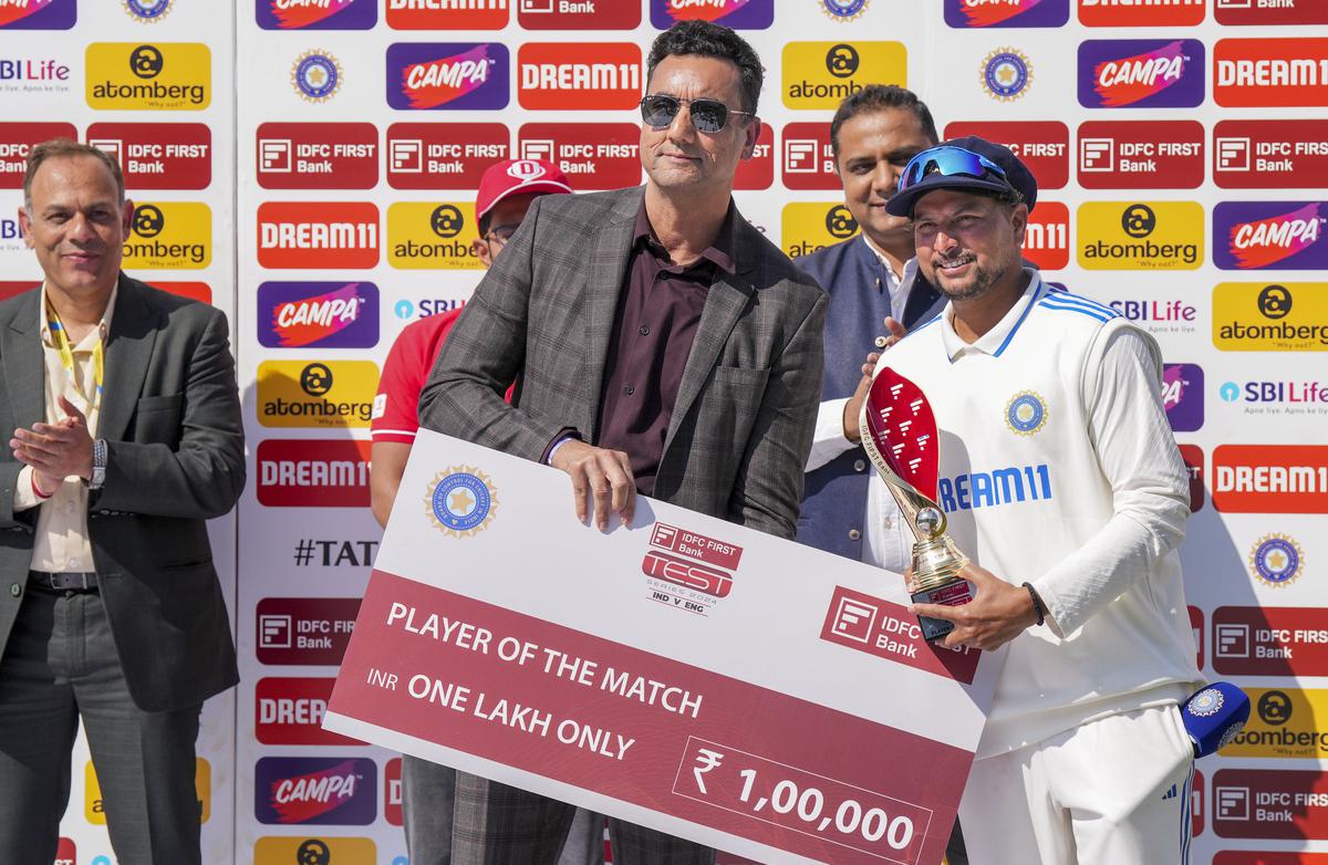 Kuldeep Yadav poses for photos after receiving the ‘Player of the Match’ during the award ceremony after India won the fifth Test cricket match against England, in Dharamsala on March 9, 2024.