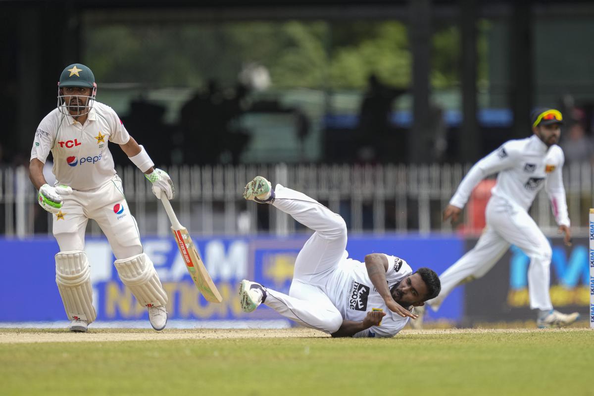 Sri Lanka’s Asitha Fernando attempts to field the ball as Pakistan’s Babar Azam watches.