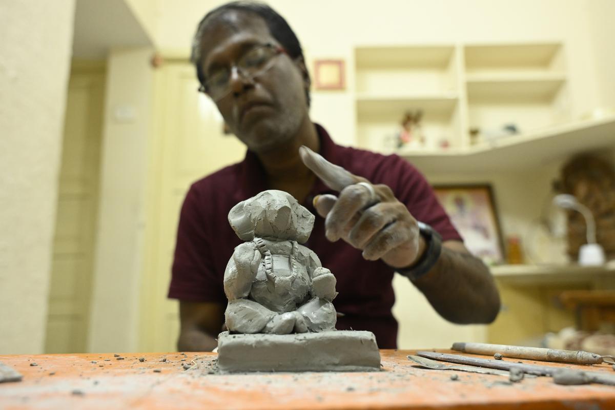 Vishal Deshpande making a clay Ganesha at home