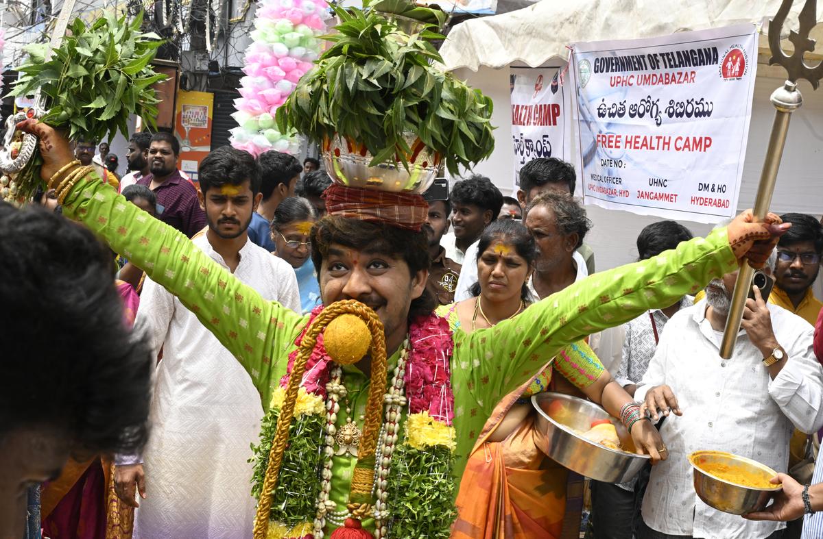 A devotee with his bonam at Lal Darwaza Simhavahini Mahankali Temple in Hyderabad on Sunday. A devotee with his bonam at Lal Darwaza Simhavahini Mahankali Temple in Hyderabad on Sunday.