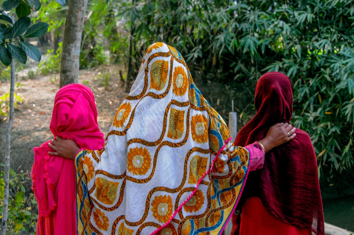 Sultana, whose husband abandoned her, making her vulnerable to trafficking, with her twin daughters.