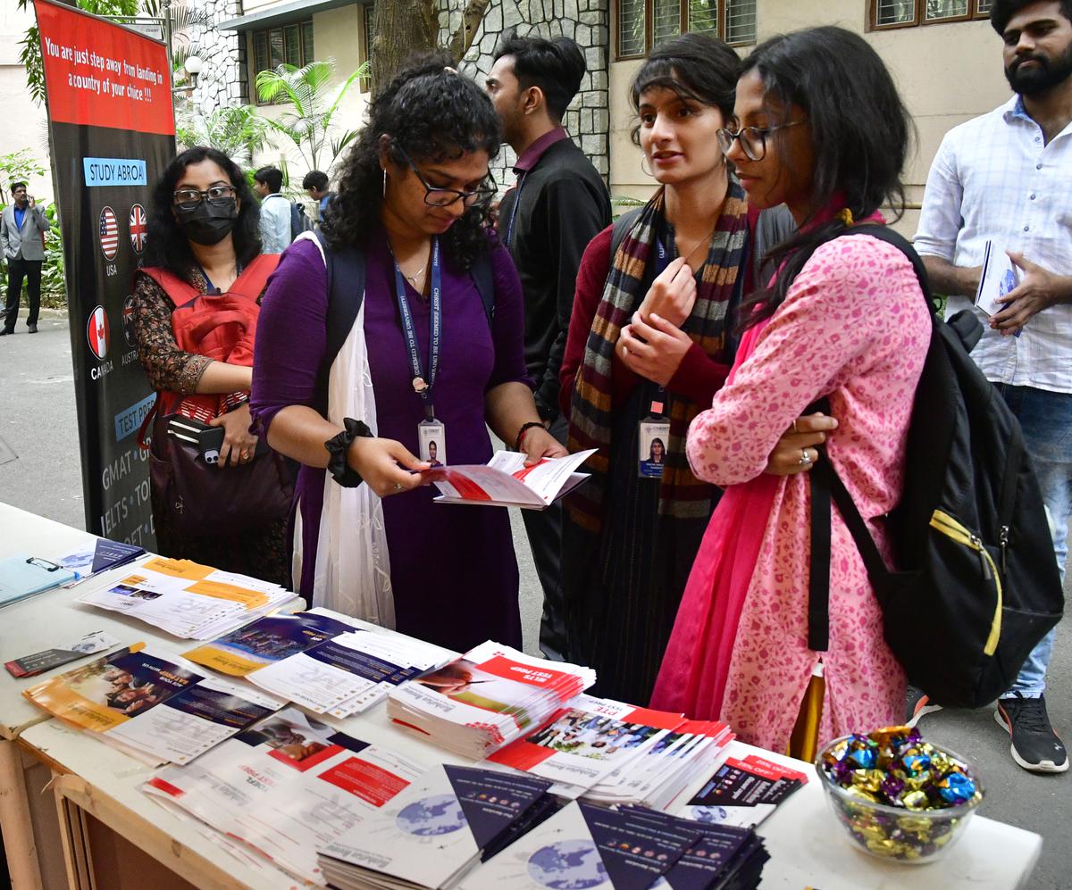 Visitors at a stall set up during The Hindu International Education Fair Christ University in Bengaluru on Monday.