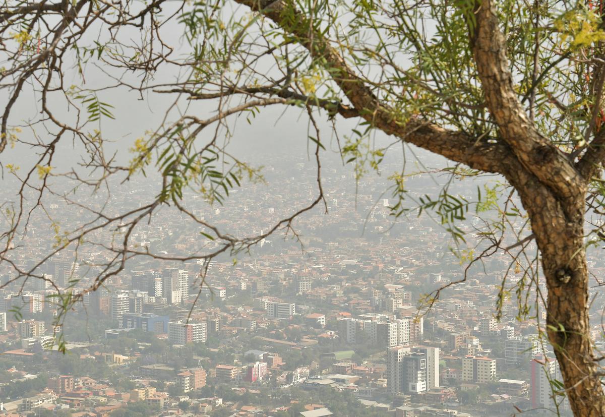 Buildings and houses stand amid smoke caused by forest fires in Cochabamba, Bolivia, September 10, 2024.