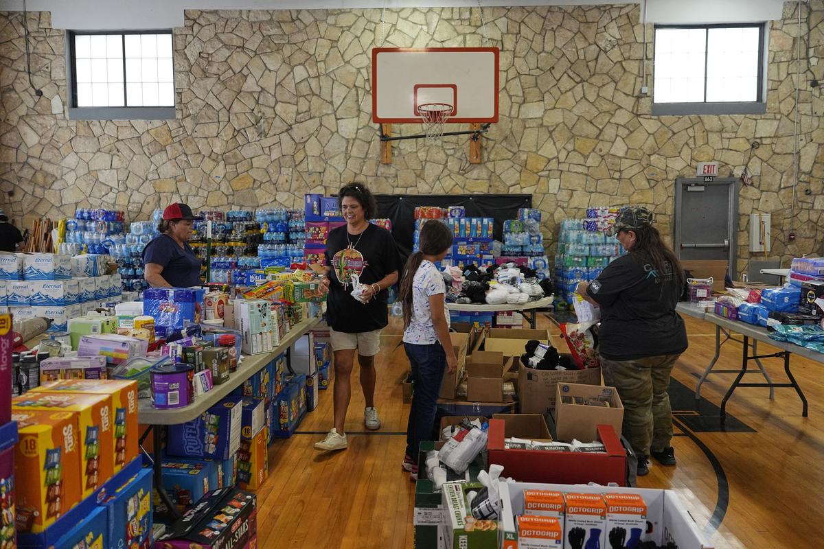 Sonia Govea, second from left, and other volunteers help organize donations for victims of flash flooding in Texas inside the gym at Center Point Elementary in Center Point, Texas, Monday, July 7, 2025. Sonia Govea, second from left, and other volunteers help organize donations for victims of flash flooding in Texas inside the gym at Center Point Elementary in Center Point, Texas, Monday, July 7, 2025.