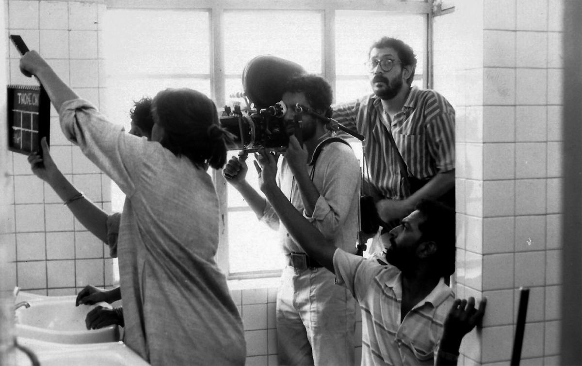 Director Pradip Krishen (extreme right) and Aradhana Seth with the clapperboard in a behind-the-scenes still during the shoot of the film.