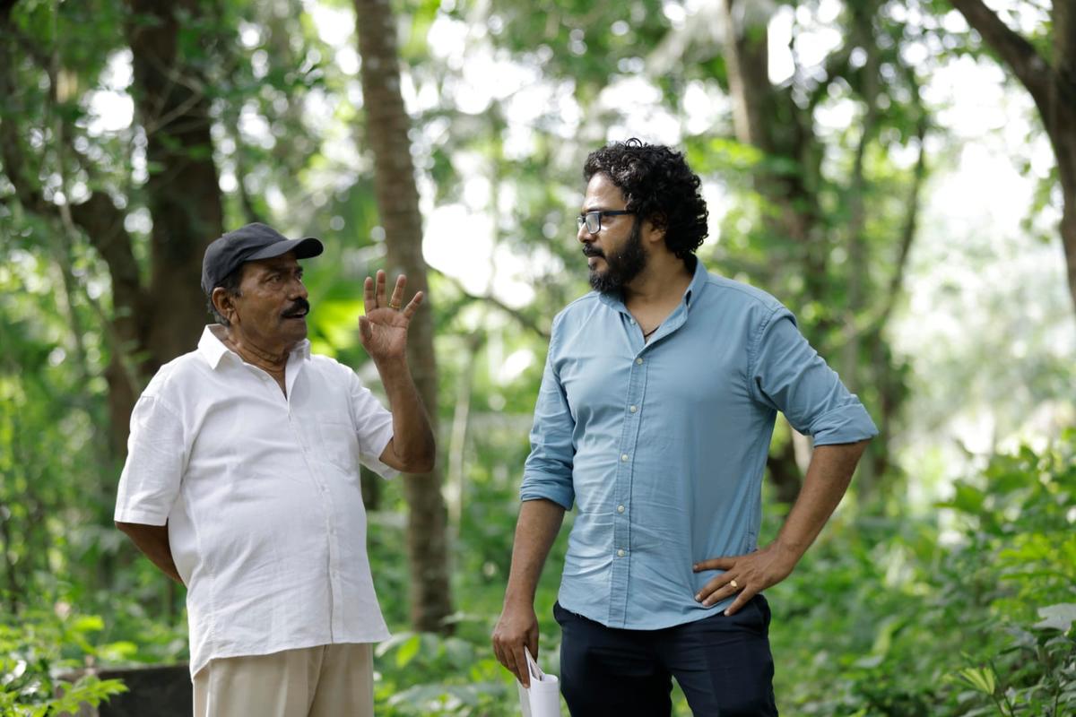 Filmmaker Dinjith Ayyathan with his father Divakaran Ayyathan on the location of Kishkindha Kaandam