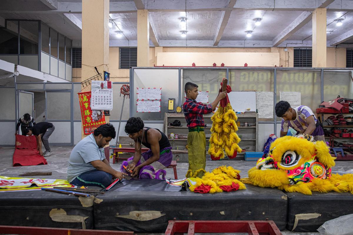 Local Indian boys prepare their costumes for the Lion Dance they perform during the Chinese New Year. As the number of young Chinese people shrink, local Indian boys keep the traditions alive.  