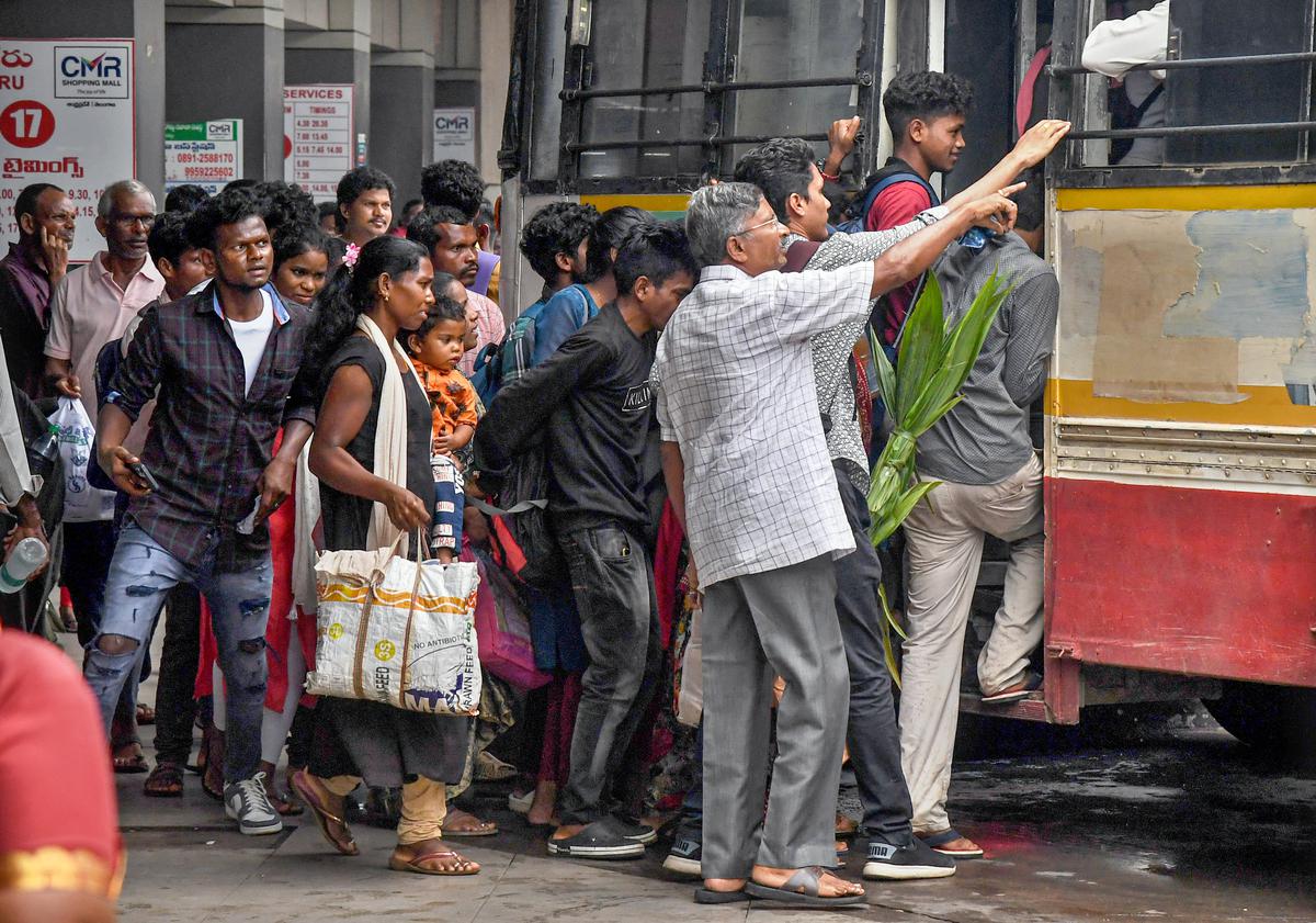 Passengers rush to board an RTC bus at Dwaraka Bus station in Visakhapatnam on Saturday. After the arrest of TDP national president N. Chandrababu Naidu, RTC buses were confined to depots for almost five hours anticipating protests. 
