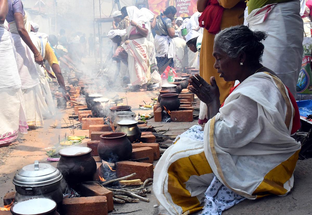 Devotees offer prayers during the annual Attukal Pongala festival , in Thiruvananthapuram on Tuesday.
 