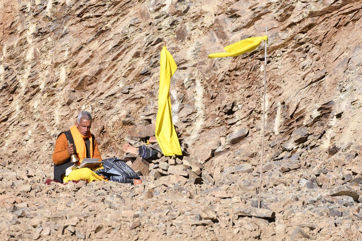 A pandit offers prayers next to the collapsed tunnel in Uttarakhand’s Uttarkashi district on November 21, 2023. 