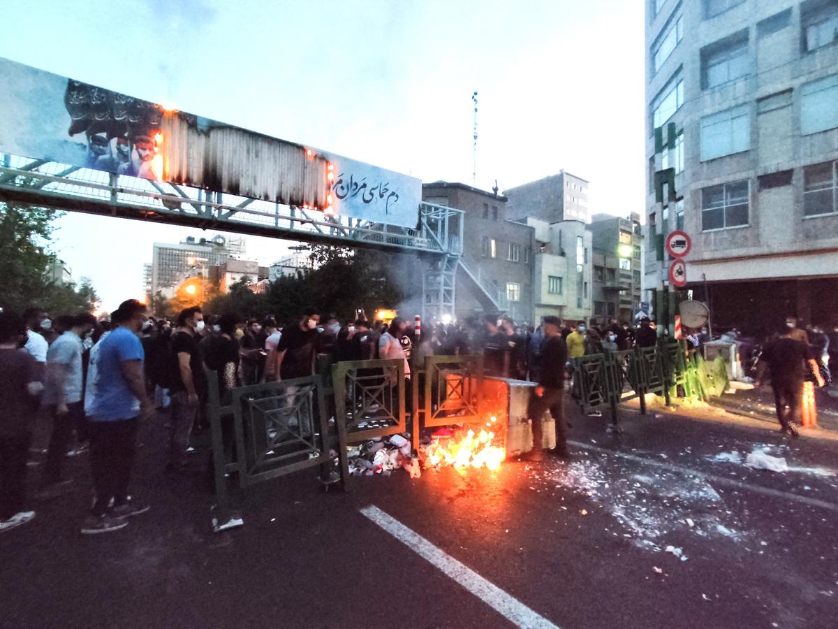 People light a fire during a protest over the death of Mahsa Amini, a woman who died after being arrested by the Islamic republic’s “morality police”, in Tehran, Iran on September 21, 2022. 