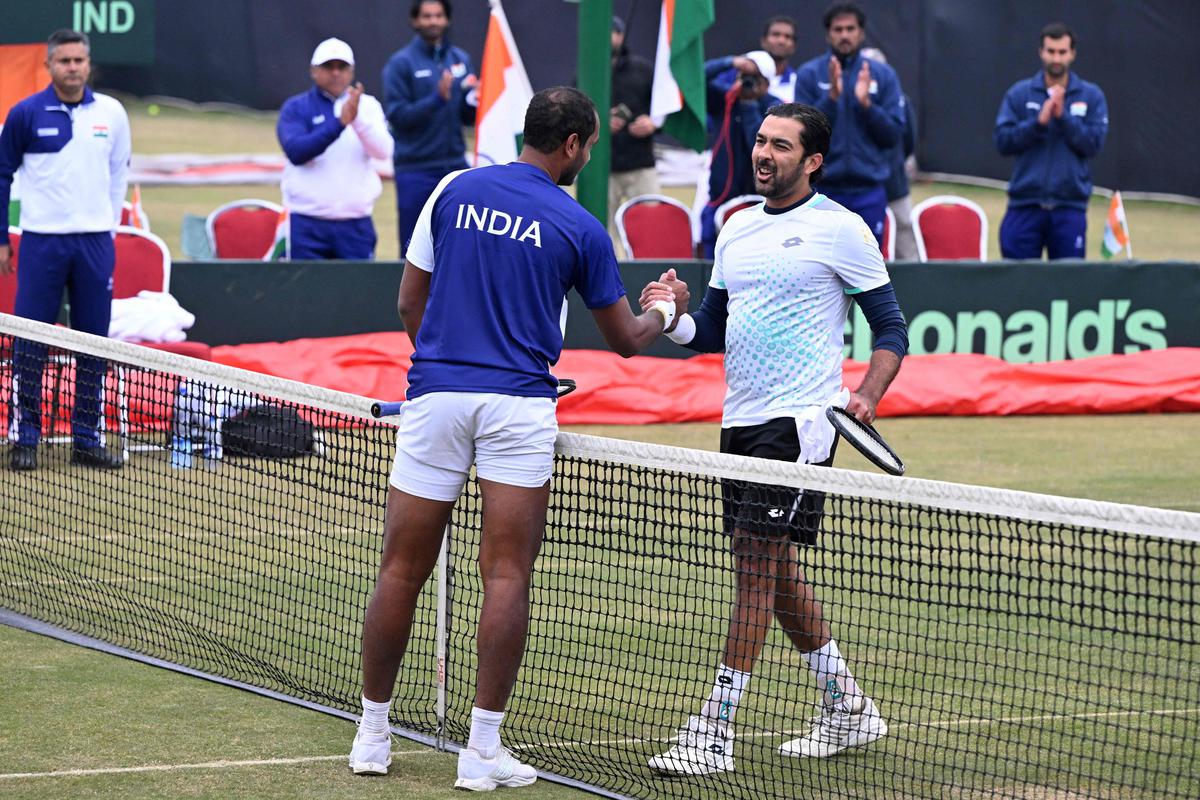 India’s Ramkumar Ramanathan greets Pakistan’s Aisam-ul-Haq Qureshi after winning the singles tennis match of the Davis Cup World Group-1 play-off between Pakistan and India, in Islamabad on February 3, 2024. 