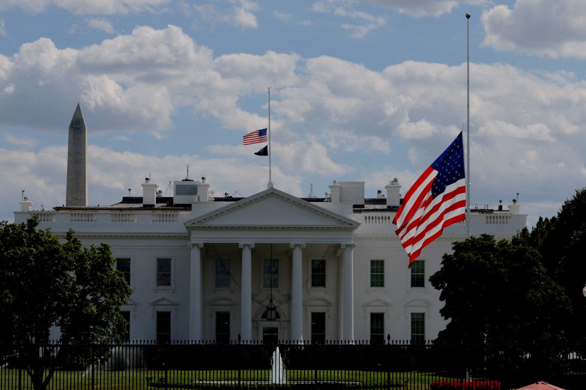 Flags fly at half-staff as a sign of mourning at the White House after U.S. President Donald Trump ordered a nationwide tribute following a deadly shooting at Annunciation Church which is also home to an elementary school in Minneapolis, in Washington, D.C., U.S., August 27, 2025. 