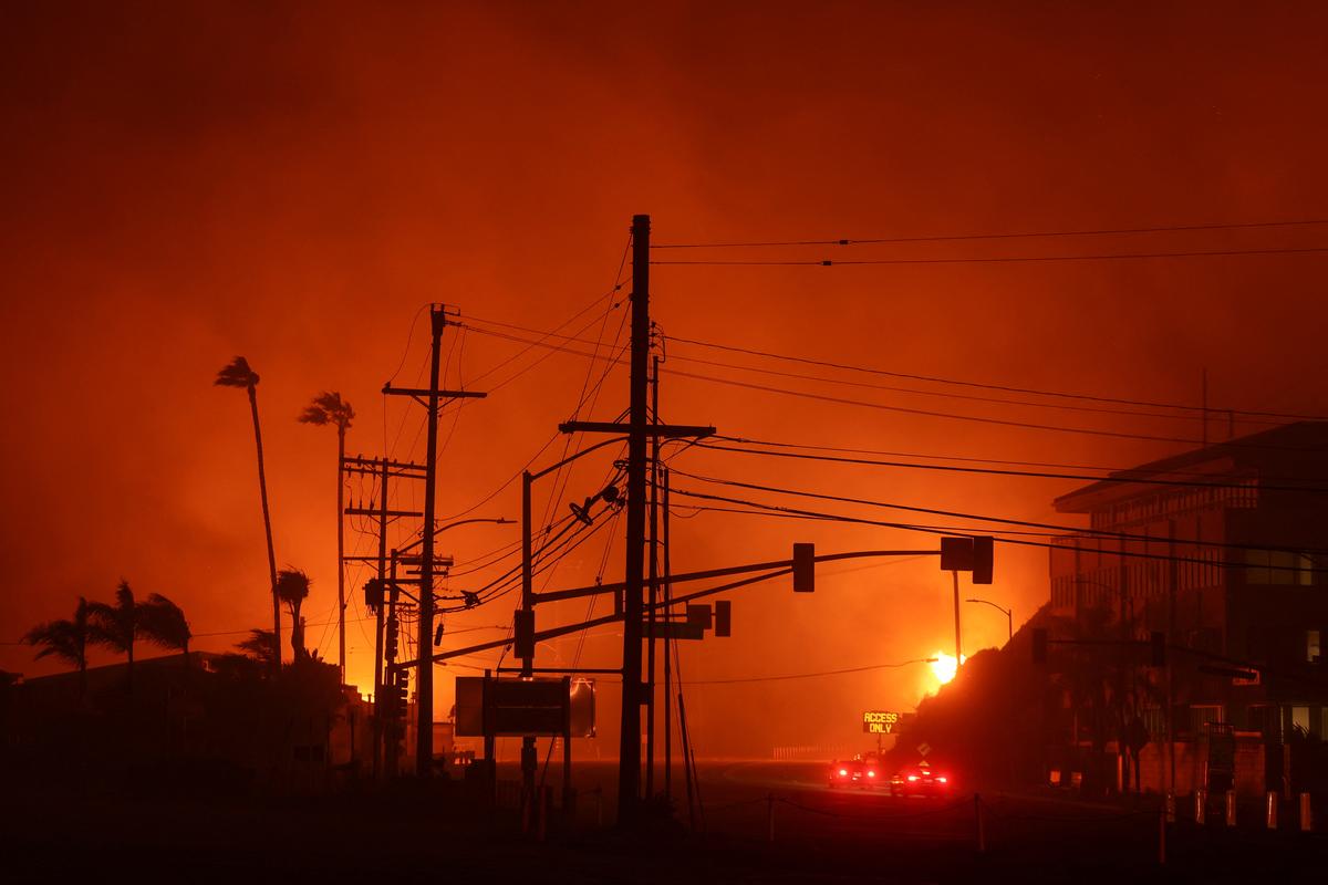 Vehicles drive along the Pacific Coast Highway, as a wildfire burns in the Pacific Palisades neighborhood of west Los Angeles, California, U.S. on January 7, 2025. 