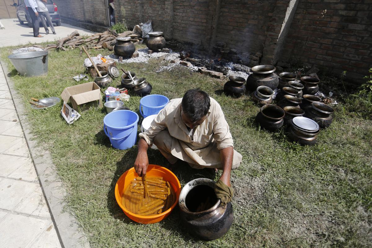 Chefs prepare wazwan during an austere marriage fuction on the outskirts of Srinagar. File